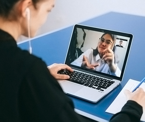 High school student attending an online class using headphones